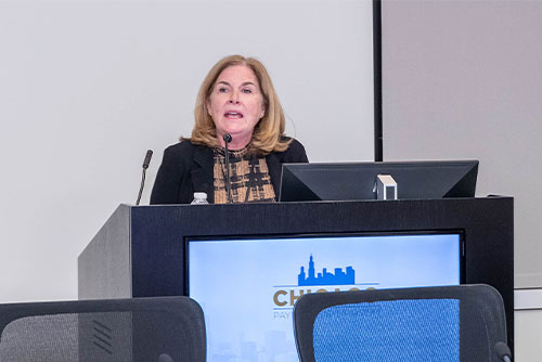 Esther George, at the time president of the Federal Reserve Bank of Kansas City, stands behind a podium to deliver a keynote address during the 2022 Chicago Payments Symposium.
