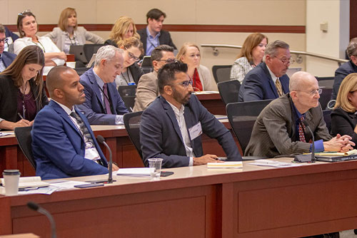 Seated audience members listen to panelists during the 2022 Chicago Payments Symposium.