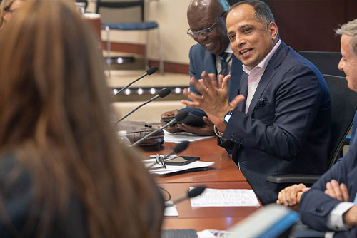 A seated global payments panelist makes eye contact with a moderator while speaking at the 2023 Chicago Payments Symposium.