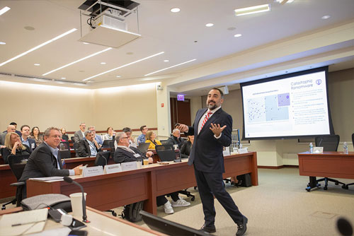 Cybersecurity keynote speaker Alex Stamos of SentinelOne presents in front of seated audience members during the 2024 Chicago Payments Symposium.
